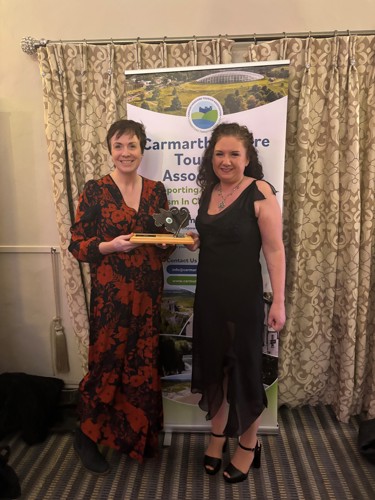 Museums Development Manager, Morrigan Mason, and Visitor Services Supervisor, Alison Moody, celebrating the Best Attraction Award for the Museum of Land Speed