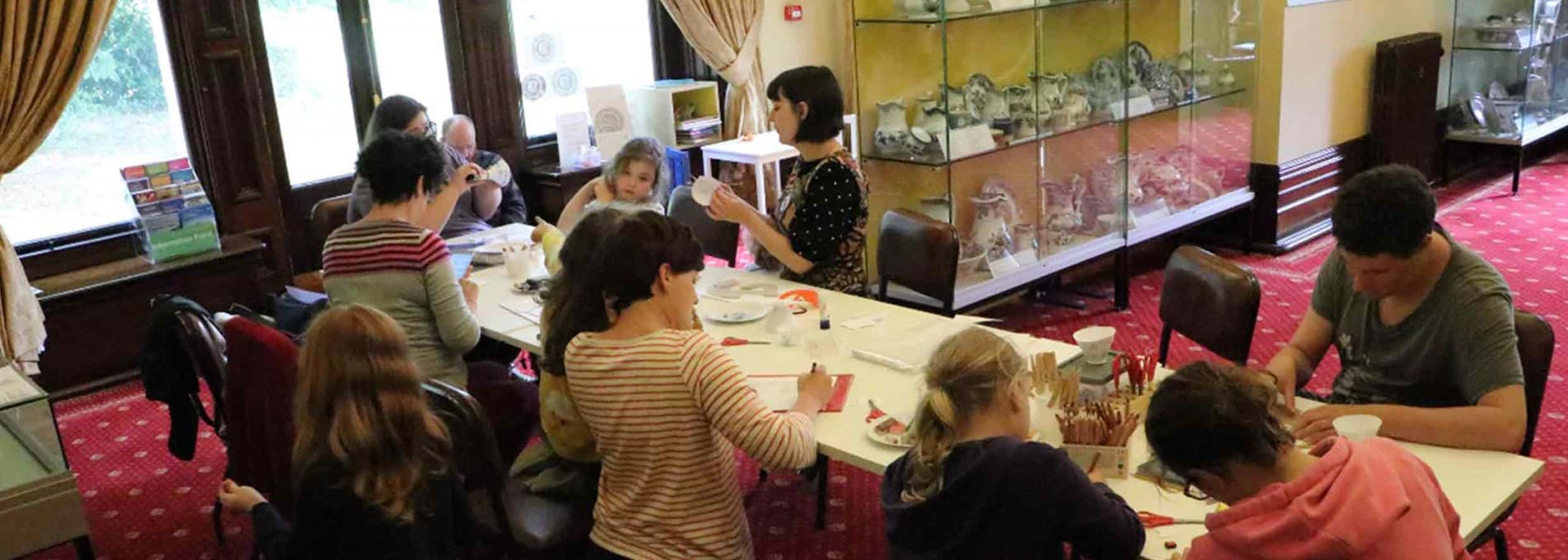Families enjoying making paper pottery in Parc Howard Museum