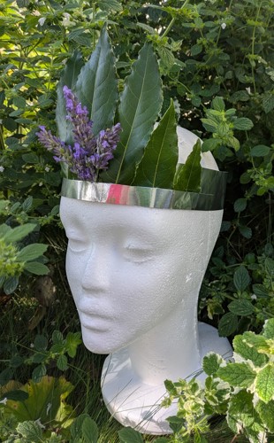 Crown of leaves and flowers on a mannequin head
