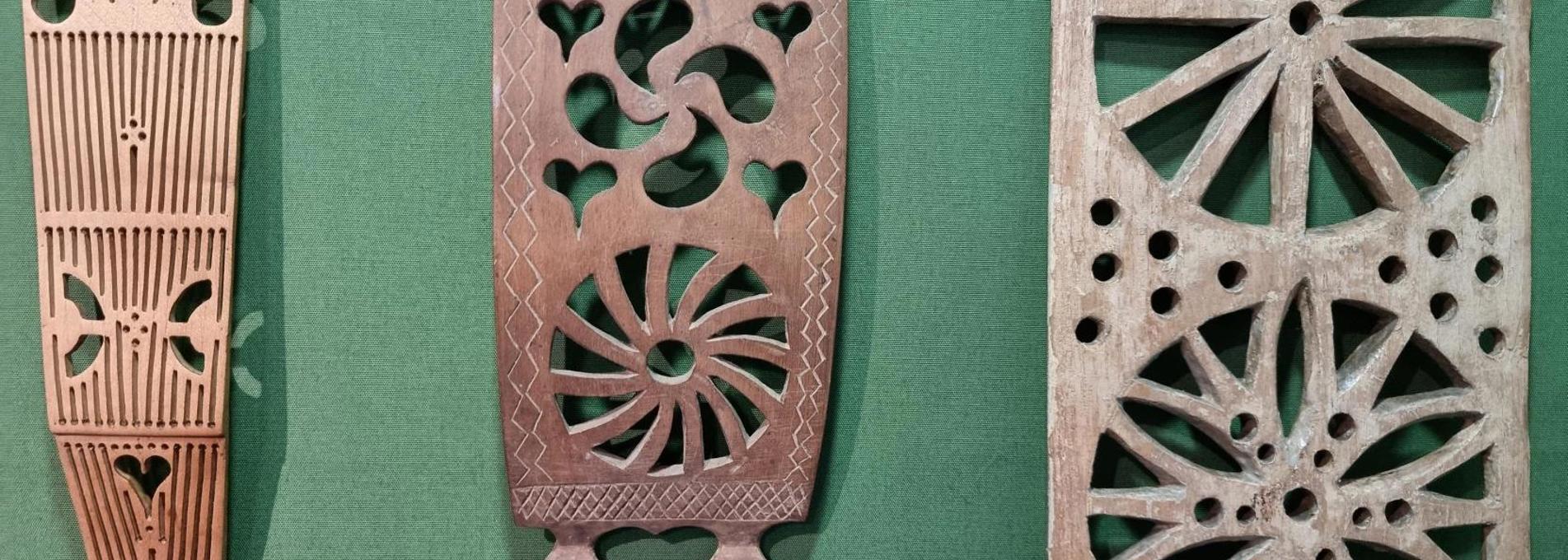 Three different lovespoons with carved decoration