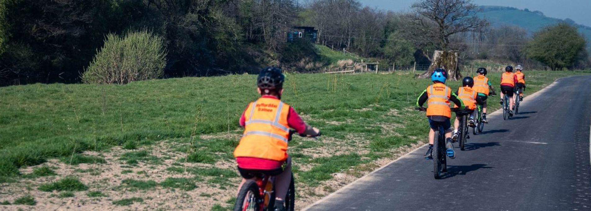 Children cycling along a pathway in the countryside